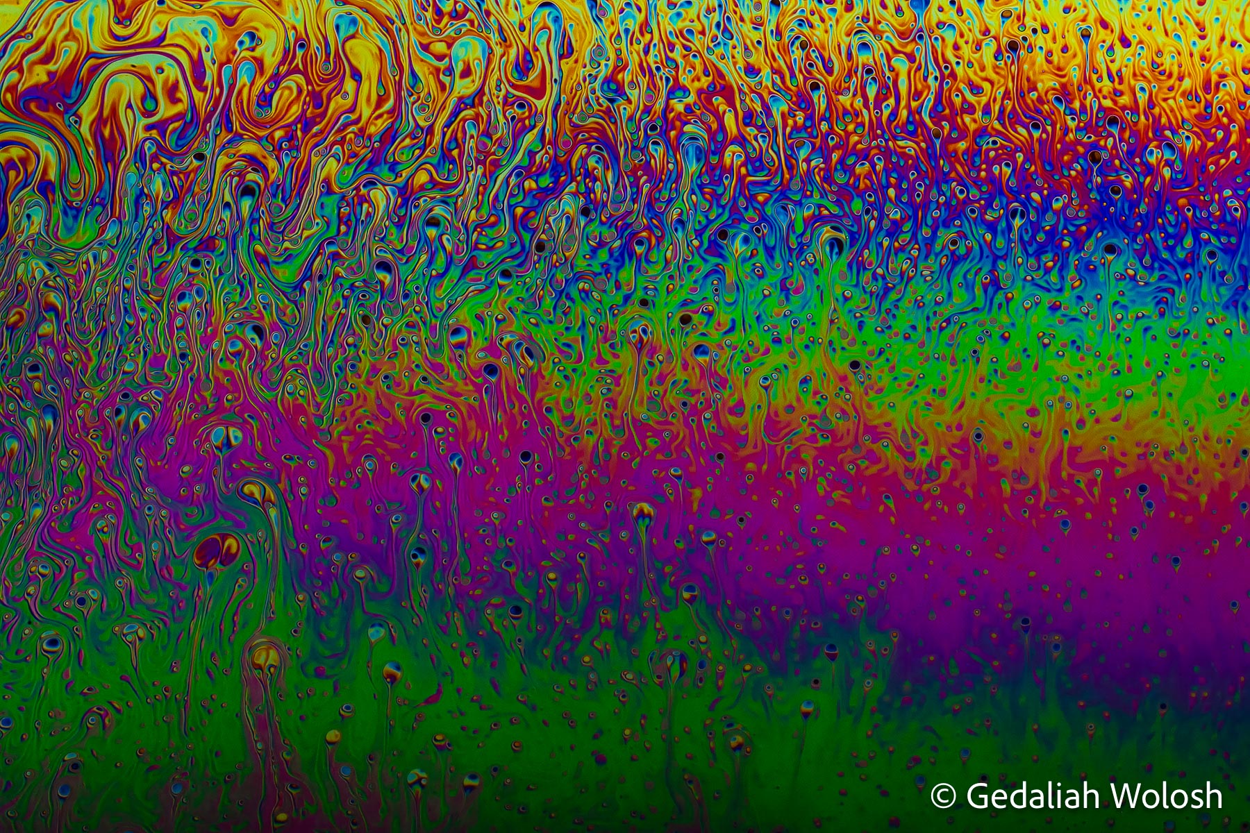 Aurora Drift A transient band of thin-film interference colors stretches across the frame like an aurora suspended in liquid. Thousands of...